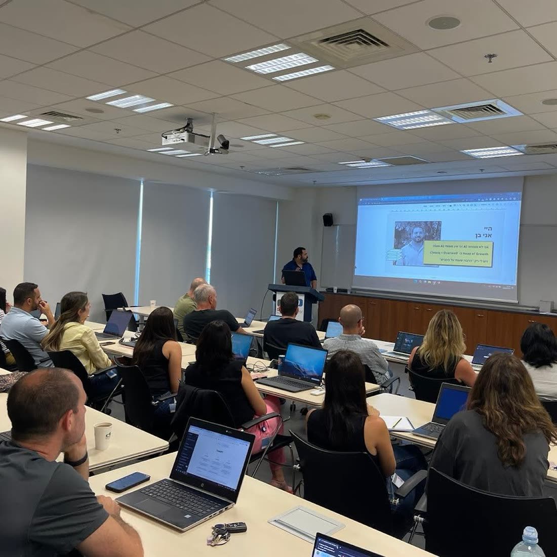 Participants working on laptops in an AI workshop